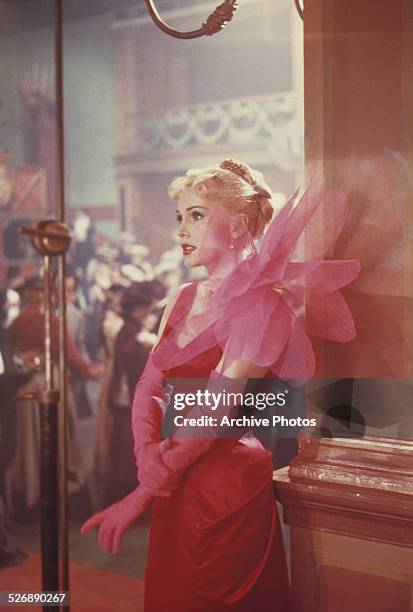 Hungarian-born American actress Zsa Zsa Gabor as she appears in the film 'Moulin Rouge', 1952. She is wearing a dress designed by Elsa Schiaparelli.