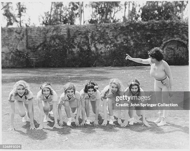Former boxer Madame Jene La Marr instructs a group of young Metro-Goldwyn-Mayer actresses. Left to right are, Lenore Bushman, Harriett Lake, Mary...