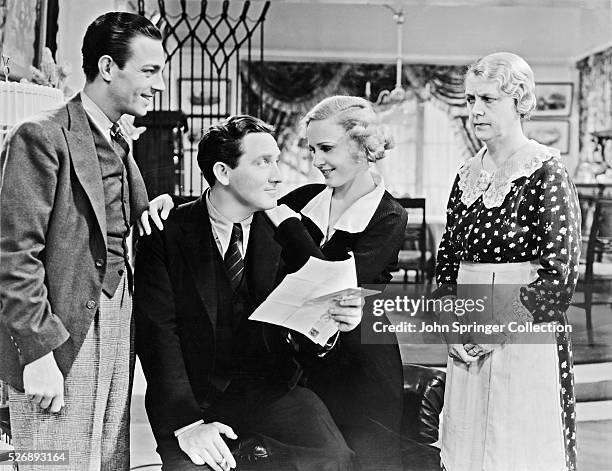 Cast members from the 1934 film The Show-Off pose together on the movie set. Left to right: Henry Wadsworth as Joe Fisher, Spencer Tracy as J. Aubrey...