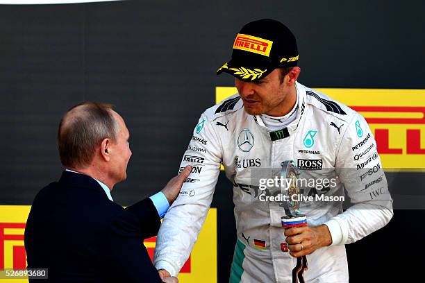 Nico Rosberg of Germany and Mercedes GP collects his winners trophy from Russian President Vladimir Putin during the Formula One Grand Prix of Russia...