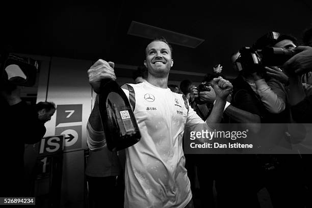 Nico Rosberg of Germany and Mercedes GP celebrates his win with the team outside the garage after the Formula One Grand Prix of Russia at Sochi...