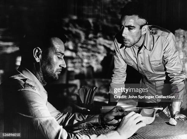 John Wayne as Colonel Joseph Madden and Anthony Quinn as Captain Andres Bonifacio in the 1945 film Back to Bataan.