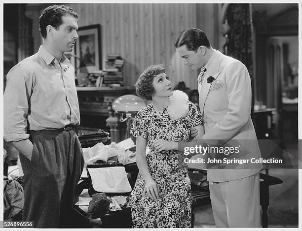 Fred MacMurray as Cyrus Anderson, Claudette Colbert as Jeannette Desmereau, and Robert Young as Jack Bristow in the 1935 comedy film The Bride Comes...