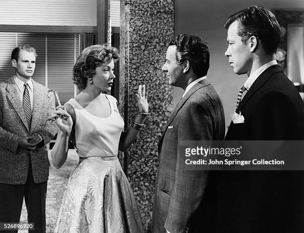 Cast members from the 1953 film The Big Heat : Adam Williams , Gloria Grahame , Alexander Scourby , and Lee Marvin .