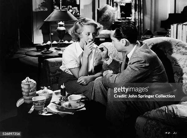 Bette Davis as Joyce Heath and Franchot Tone as Donald Bellows in the 1935 film Dangerous.