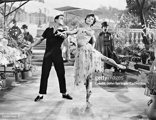 Gene Kelly as Jerry Mulligan dances with Leslie Caron as Lise Bouvier in the 1951 An American in Paris.