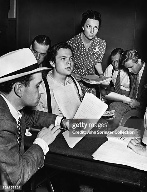 Orson Welles and other members of the Mercury Theater rehearse for the broadcast of A Tale of Two Cities for the 1938 radio program First Person...