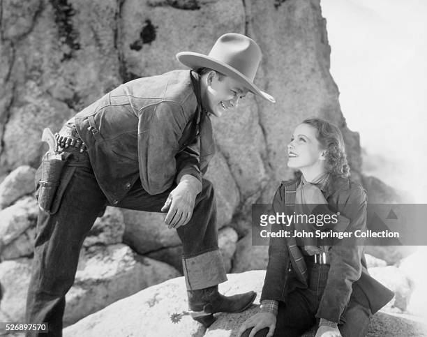 Tex Ritter in a grand national picture, "Sing, Cowboy, Sing", with Louise Stanley. Undated photograph.
