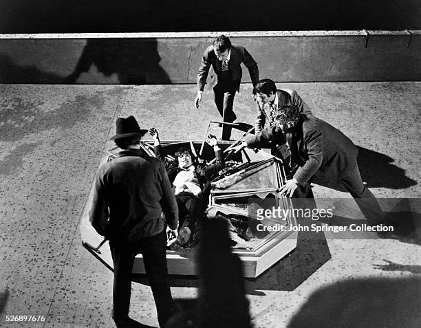 Killer Dr. Casoni falls through a skylight during the climactic scene of the 1971 film Il Gatto a nove code .