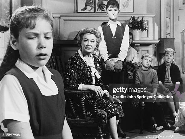 Student Mary Tilford played by Karen Balkin in a scene with Miriam Hopkins as Lily Mortar, and Audrey Hepburn as Karen Wright in the film The...