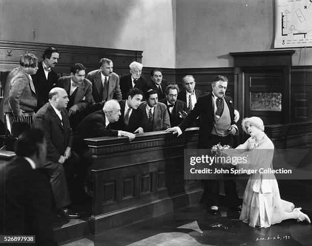 Roxie Hart pleads with the jury during her murder trial as her lawyer Flynn looks on in a scene from Chicago .