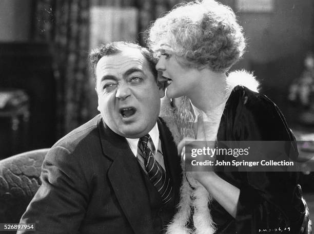 Roxie Hart bites her husband Amos' ear in a scene from Chicago .