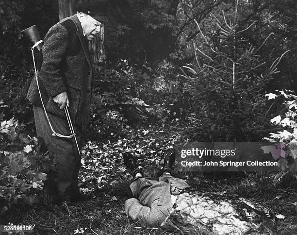 Captain Wiles discovers a body in a scene from Alfred Hitchcock's 1955 film The Trouble with Harry.