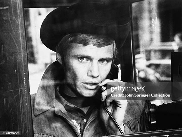 Joe Buck makes a telephone call in Midnight Cowboy.