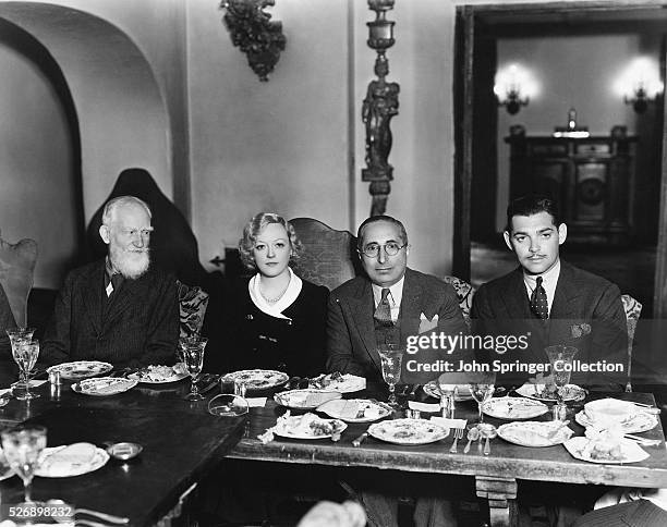 George Bernard Shaw, Marion Davies, Louis B. Mayer, and Clark Gable seated at a banquet table during a luncheon given for Mr. Shaw.