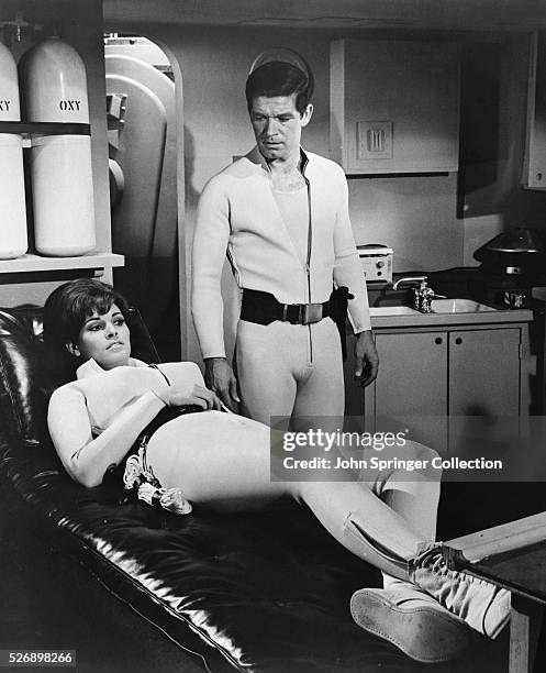 Raquel Welch as technician Cora Peterson, and Stephen Boyd as communications officer Grant in the 1966 sci-fi film Fantastic Voyage.