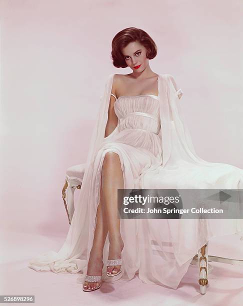 Natalie Wood , actress shown seated wearing a white sexy gown. Undated color slide.