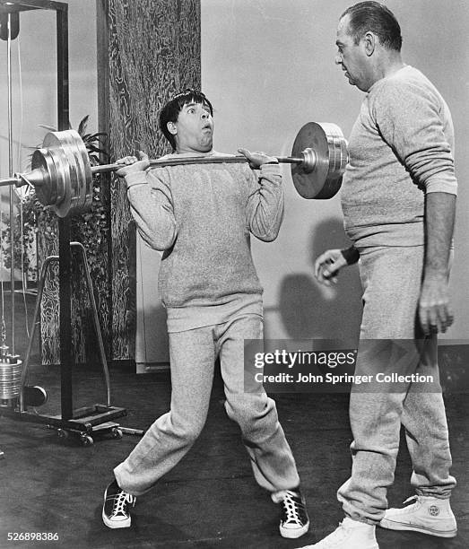 Professor Julius Kelp struggles to lift weights in a scene from the 1963 comedy The Nutty Professor.