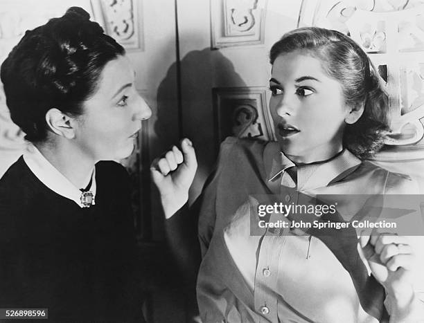 Mrs. Danvers startles the second Mrs. De Winter in Rebecca.