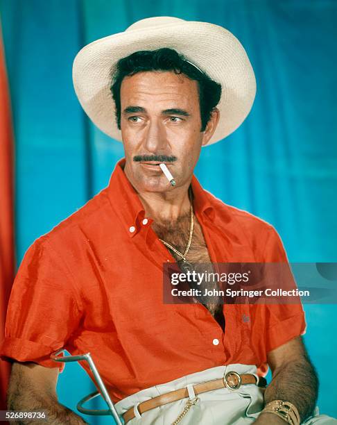 GILBERT ROLAND B.1905. WITH CIGARETTE. UNDATED PHOTOGRAPH.