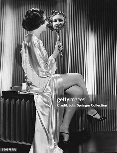Actress Shirley Ross Looking into Mirror