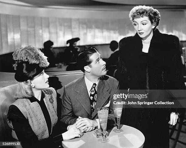 Mary Price confronts her husband Joe Parker with his mistress Susy in a scene from the 1945 film Guest Wife.