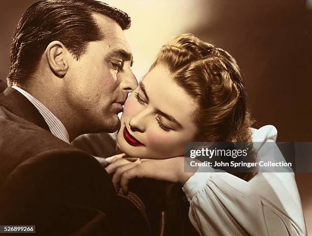 Devlin kisses the cheek of Alicia Huberman in a publicity still for Notorious.