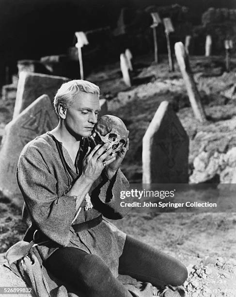 Laurence Olivier, in the role of Hamlet, holds the skull of Yorick in the graveyard scene from the 1948 film adaptation of the Shakespearean play...