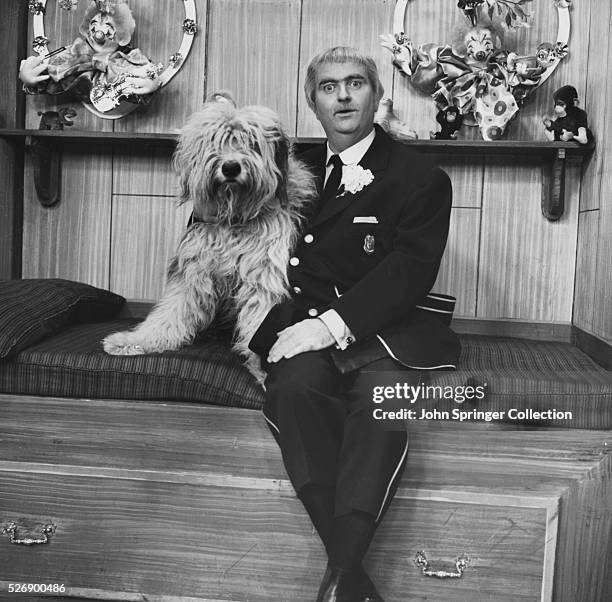 Television still featuring Captain Kangaroo with a dog on the popular kid's television show, "Captain Kangaroo."