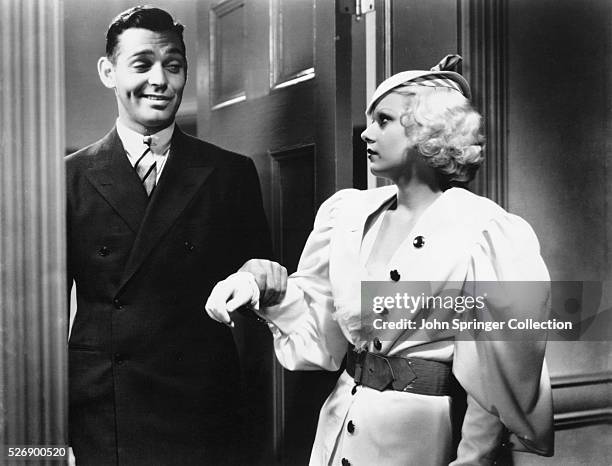 Movie still from the 1933 film, "Hold Your Man." In this scene, Clark Gable appears in the doorway as Jean Harlow looks at him.