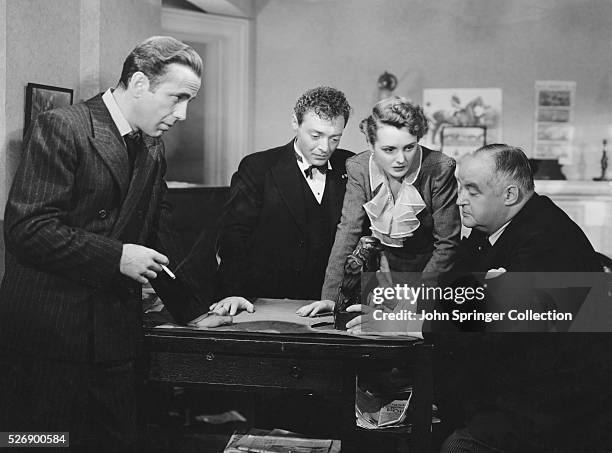 Actors in The Maltese Falcon from left: Humphrey Bogart, Peter Lorre, Mary Astor, and Sydney Greenstreet. Motion pictured released in 1941.