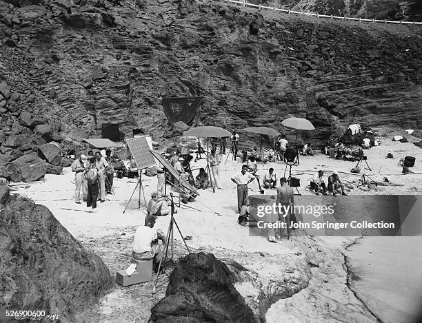 Fred Zinnemann directs Burt Lancaster and Deborah Kerr in the famous beach scene from From Here to Eternity .