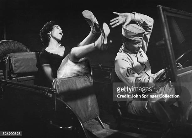Carmen Jones distracts Joe in a scene from the 1954 film Carmen Jones.