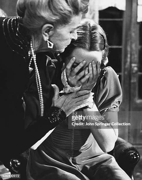 Mrs. Railton-Bell comforts her crying daughter Sibyl Railton-Bell in the 1958 film Separate Tables.