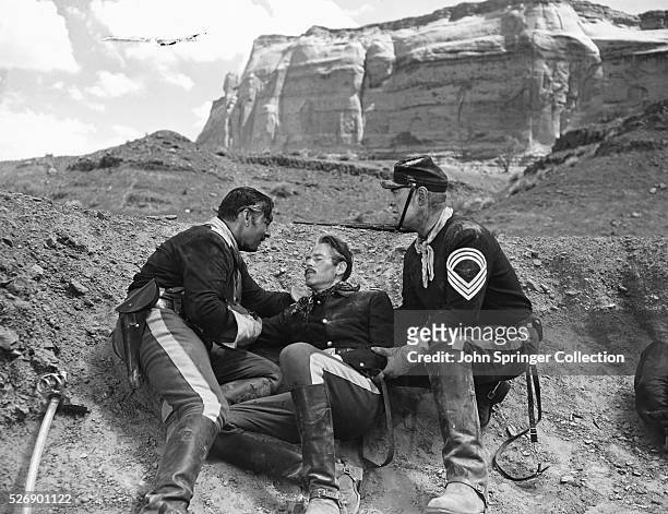 Col. Owen Thursday lies wounded after his Cavalry troop is attacked, in John Ford's Fort Apache. To the right is Ward Bond as Sgt. Maj. Michael...