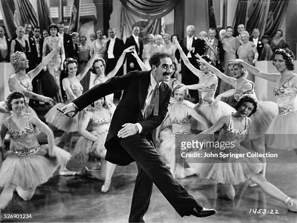 Groucho Marx dances with the Corps de Ballet in a scene from the film Duck Soup.