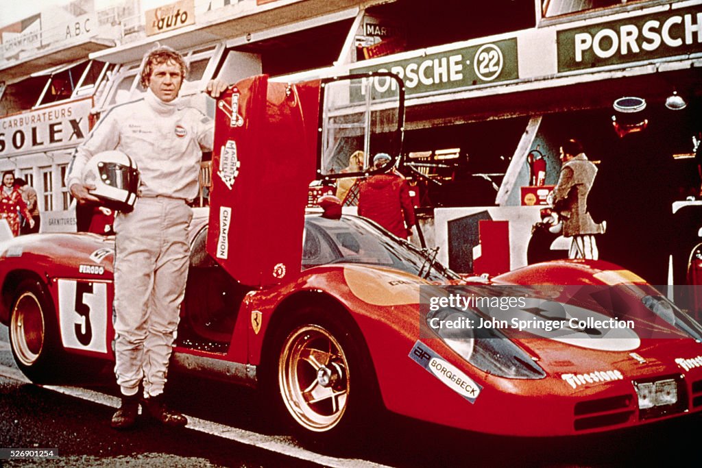 Steve McQueen Stands Next to Race Car