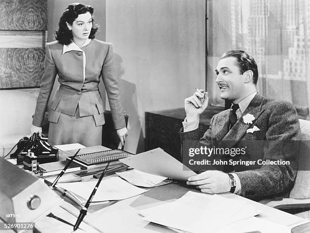 Actress Rosalind Russell as secretary Kendal Browning and actor Brian Aherne as advertising executive Stephen Dexter in the 1940 comedy Hired Wife....