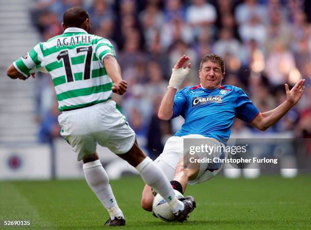 Celtic's Didier Agathe evades a tackle from Rangers' Gregory Vignal during Scottish Premier League match between Glasgow Rangers and Celtic at Ibrox,...