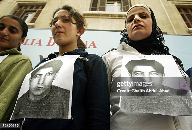 Syrian human rights activists display pictures of Rshid Mahmood al-Sheik, demanding his release from jail, in front of the State Security Court In...