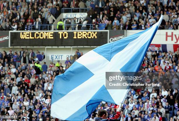 Saltire is raised on the pitch to welcome the teams before the infamous 'Old Firm Game' in the Scottish Premier League between Glasgow Rangers and...