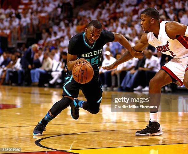 Kemba Walker of the Charlotte Hornets drives past Joe Johnson of the Miami Heat during Game Seven of the Eastern Conference Quarterfinals of the 2016...