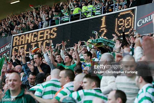 Celtic fans celebrate their 1-2 win over Rangers at the end of the infamous 'Old Firm Game' in the Scottish Premier League between Glasgow Rangers...