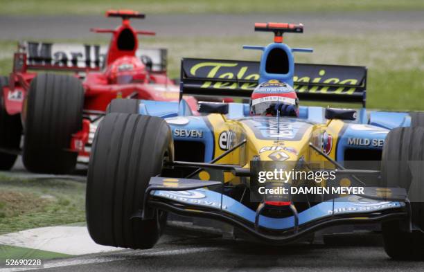 Spanish Renault driver Fernando Alonso steers his car ahead of German Ferrari driver Michael Schumacher on the Imola racetrack during the San Marino...