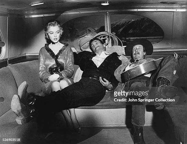 Cherie , Bo Decker , and Virgil Blessing ride a bus during a scene from the 1956 film Bus Stop.