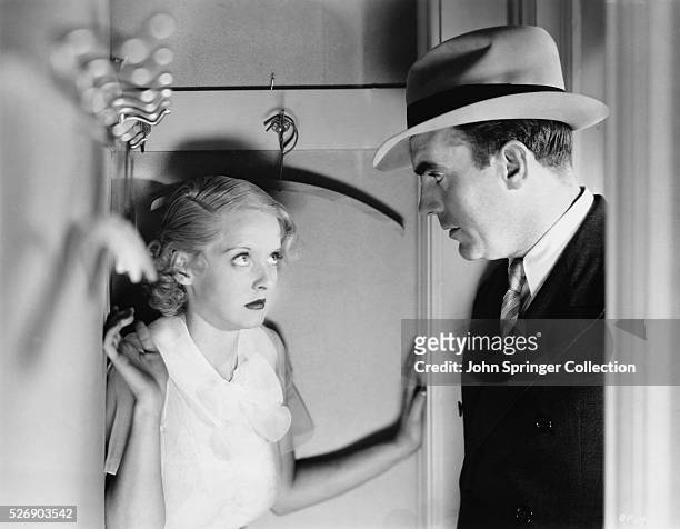 Bette Davis as Norma Roberts and Pat O'Brien as Detective Saunders in the 1933 film Bureau of Missing Persons.