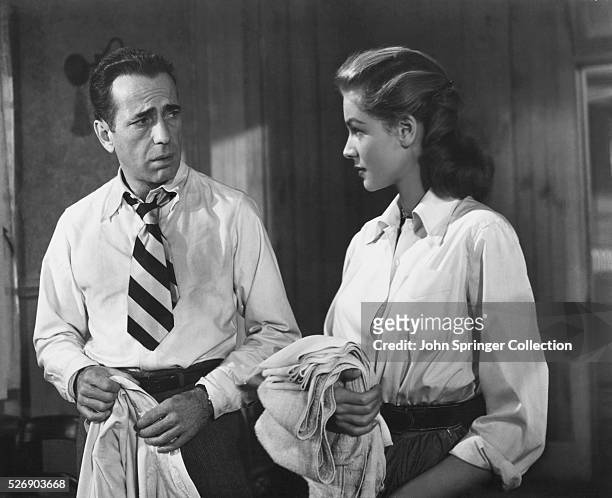 Frank McCloud and Nora Temple stare at one another in a scene from the 1948 film Key Largo.