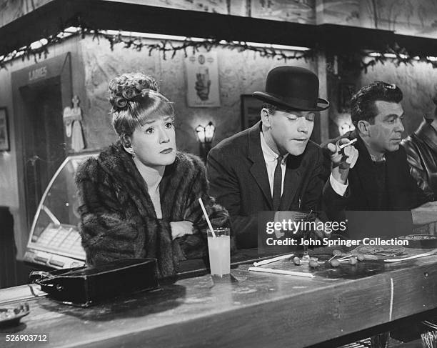 Baxter sits with Margie MacDougall while drinking martinis at a bar in the 1960 comedy The Apartment.