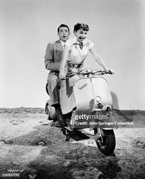 Gregory Peck and Audrey Hepburn practice a moped scene for the 1953 comedic romance Roman Holiday, in which Peck plays the role of journalist Joe...