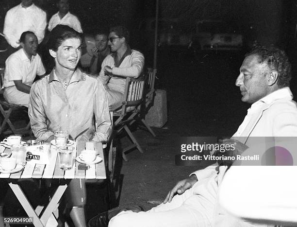 American First Lady Jacqueline Kennedy with Italian tycoon Gianni Agnelli, principal shareholder of Italian carmaker Fiat, sit at a bar in Ravello,...